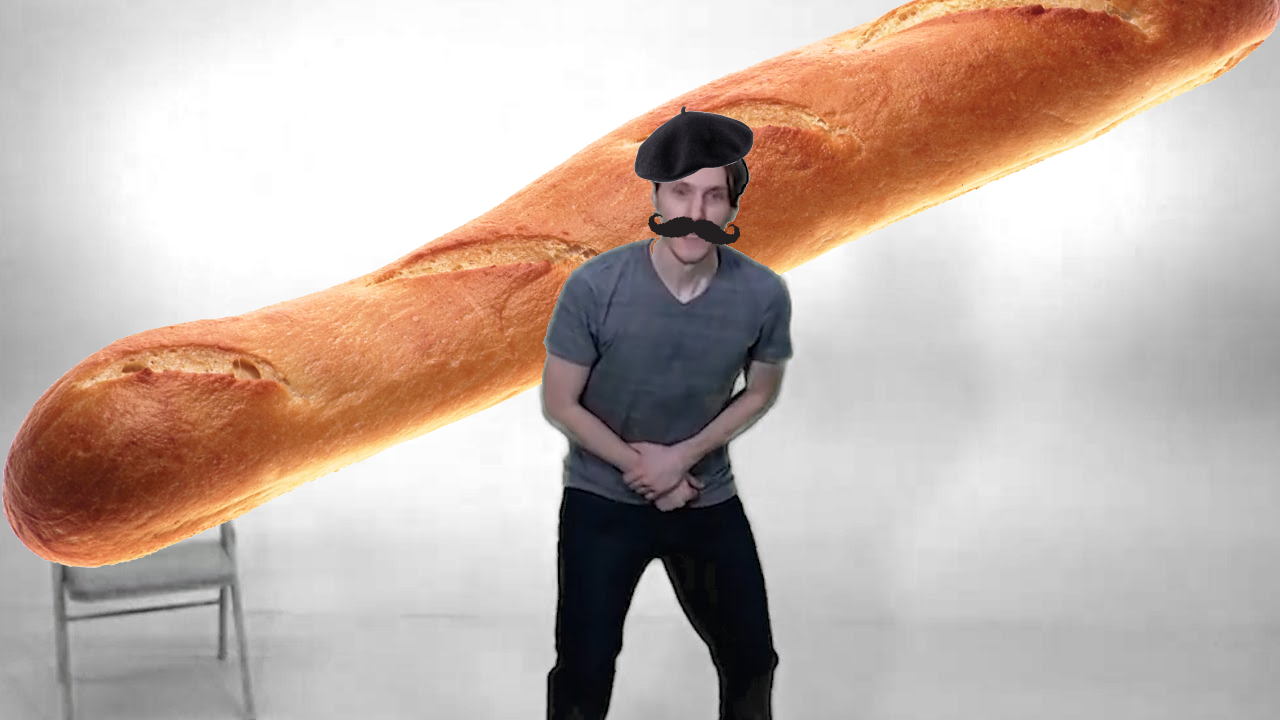 Jerma with a baret and mustache photoshopped on. There is a gigantic baguette in the background.